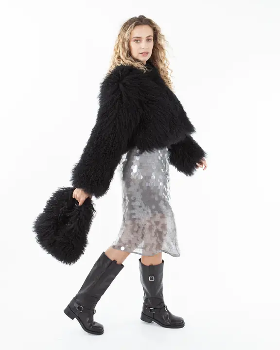 Full-length model portfolio portrait with black shearling jacket and boots