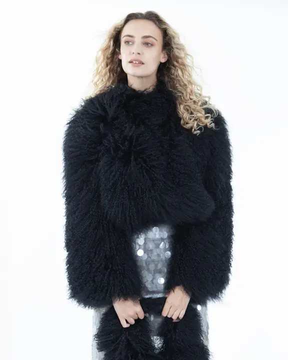 Beauty portrait of a model wearing a textured black shearling jacket