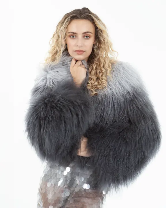 Fashion headshot of a model in a grey textured shearling coat