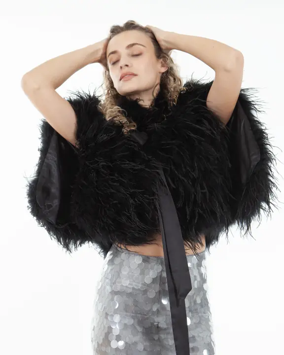 Expressive model portfolio portrait in a black feather jacket