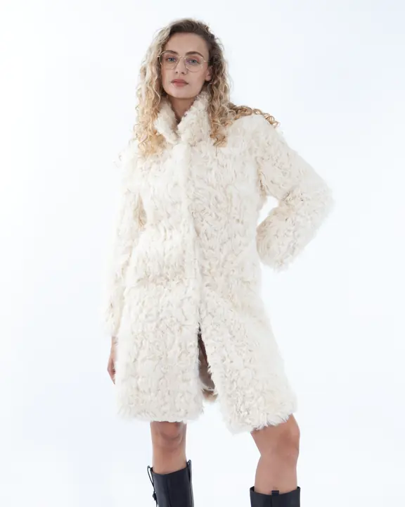 Full-length London fashion portfolio portrait in a cream shearling coat