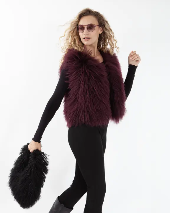 Fashion model wearing sunglasses and a burgundy shearling gilet